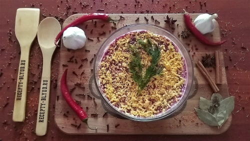 Яичный желток натереть на мелкой тёрке, посыпать сверху. Украсить готовый салат на свой вкус.